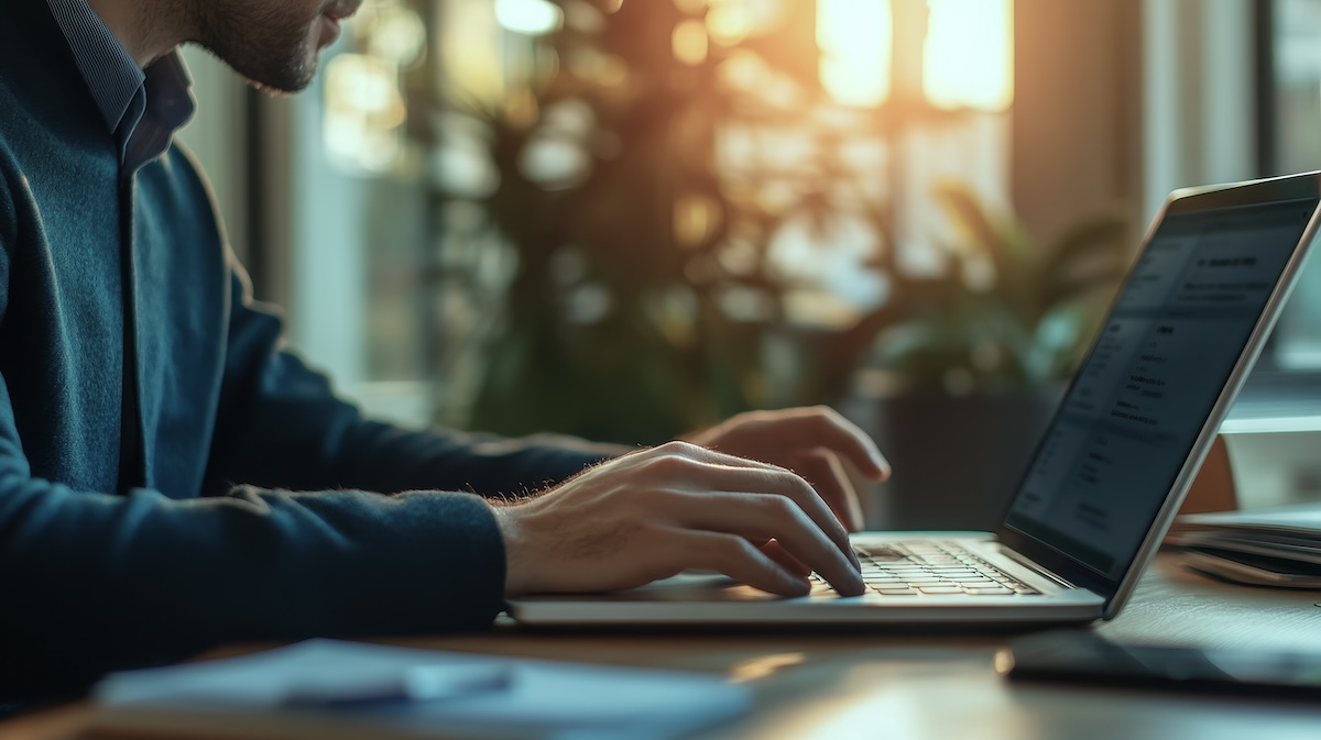 Businessman engaged in reading a website on laptop