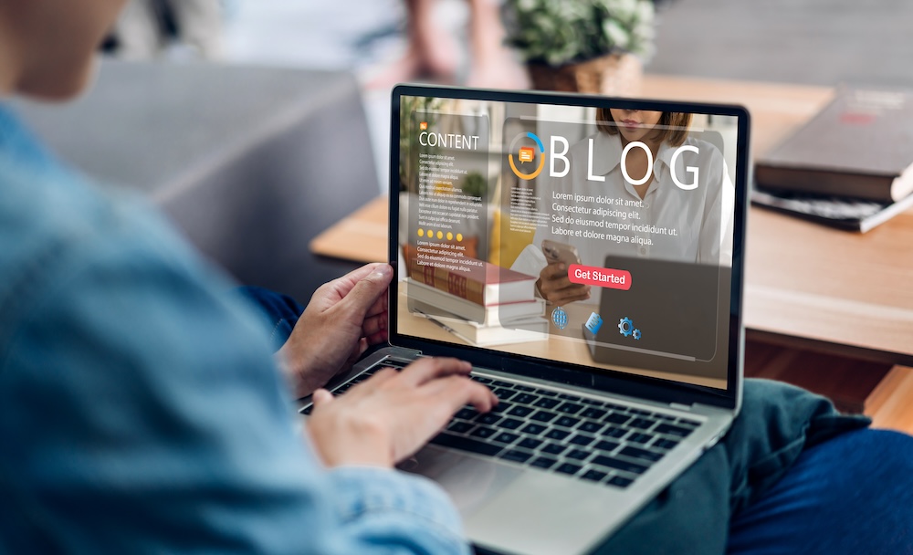 Woman ues laptop computer with social media online content, freelance worker, working online, content creator, blogger, technology, website, woman reading blog online on computer at home